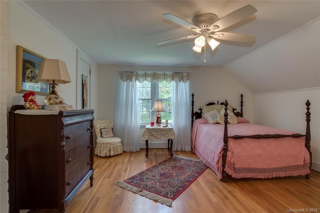 194 Harris Street Rutherfordton, NC 28139 - Photo 17 of 24 a bedroom with a bed and wooden floor