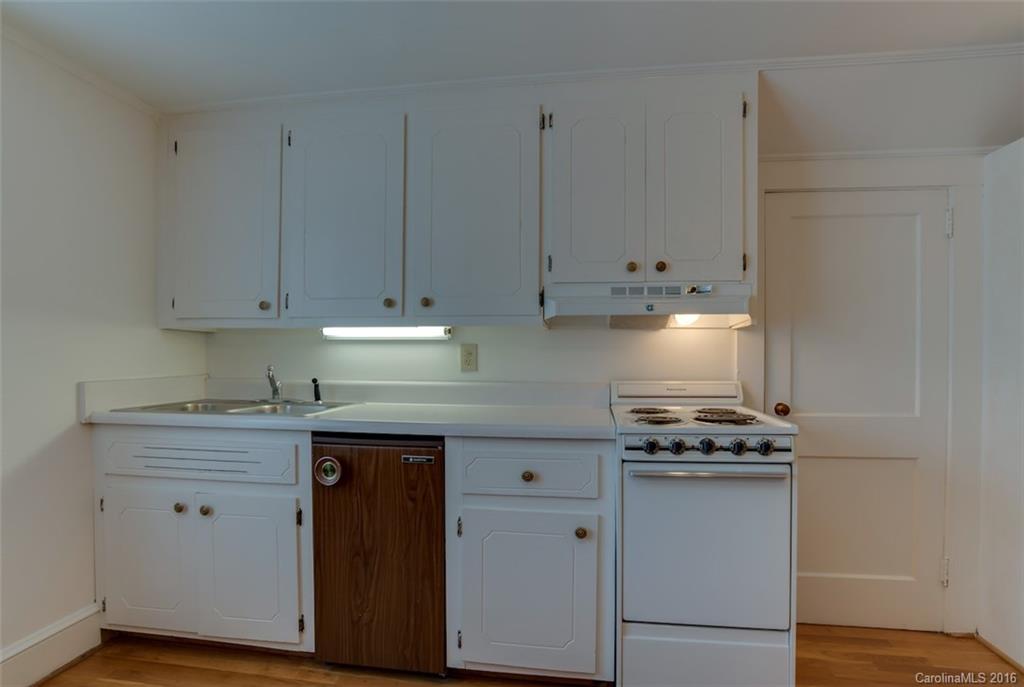 194 Harris Street Rutherfordton, NC 28139 - Photo 20 of 24 a kitchen with stainless steel appliances granite countertop a stove a sink and white cabinets