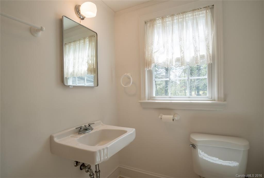194 Harris Street Rutherfordton, NC 28139 - Photo 21 of 24 a bathroom with a toilet sink and mirror
