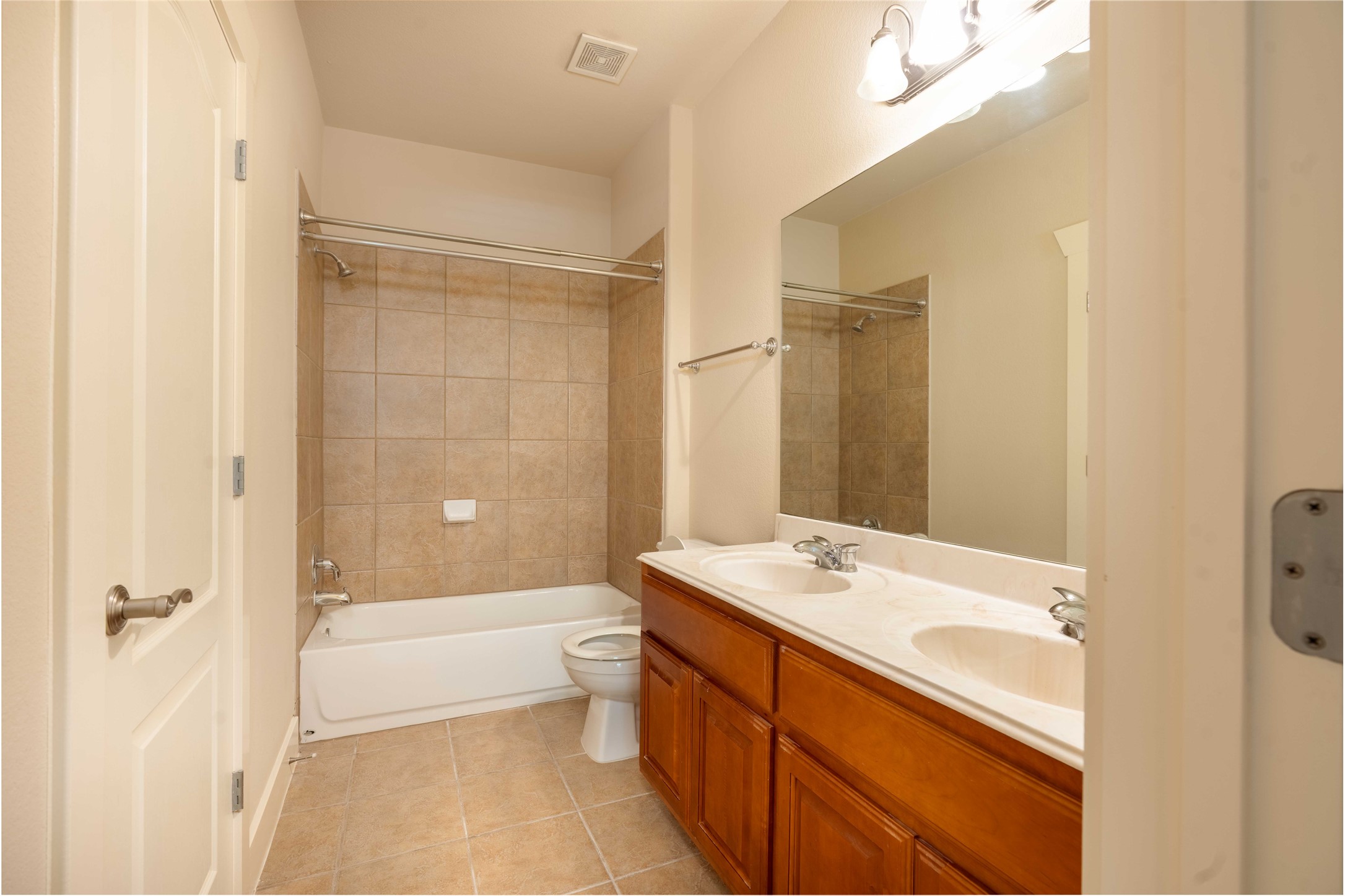 210 Rivulet Lane Austin, TX 78738 - Photo 22 of 28 Double vanity sinks and tiled bath-shower combination offer everyday convenience.