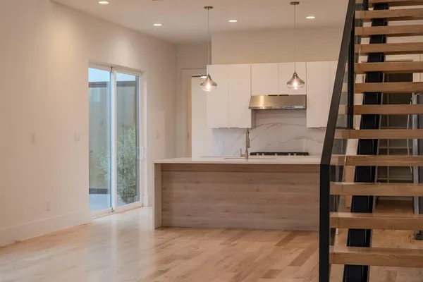 a view of kitchen with stainless steel appliances and cabinets