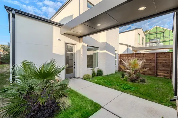 a view of a house with a yard and plants