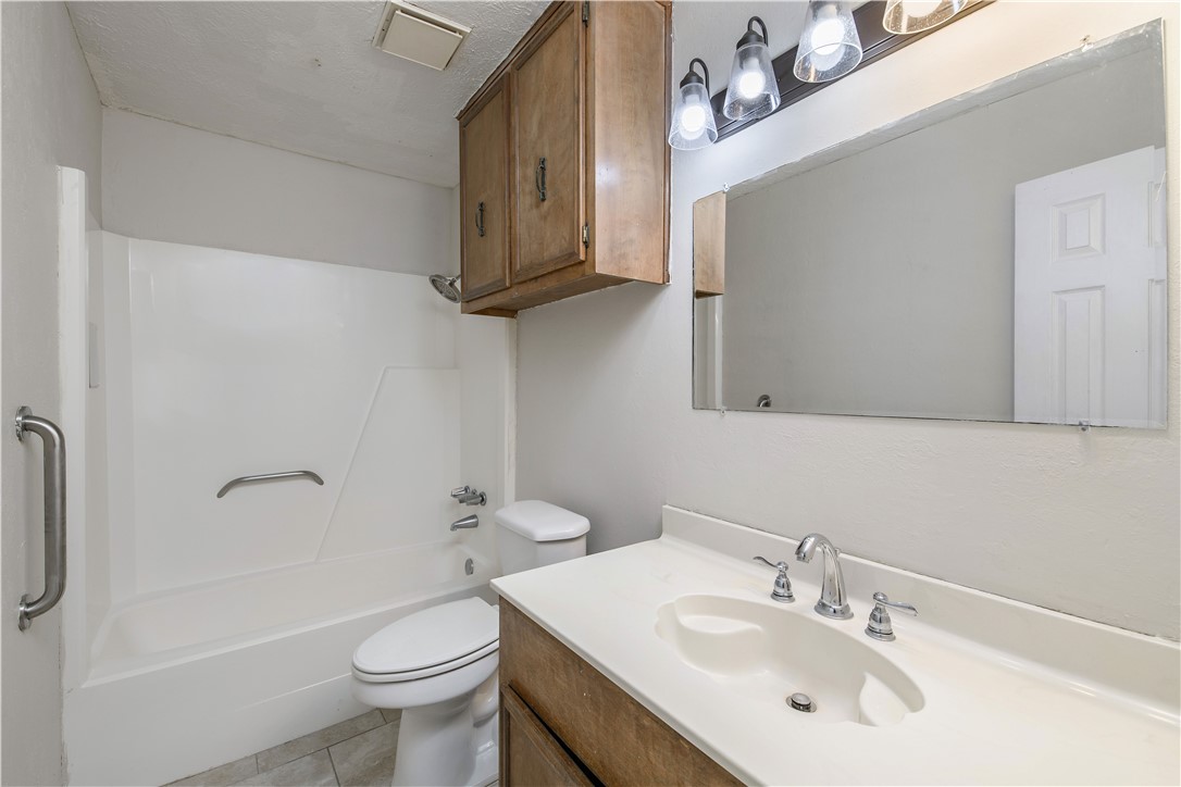 4403 Robinhood Circle Bryan, TX 77803 - Photo 14 of 19 a bathroom with a sink toilet and shower