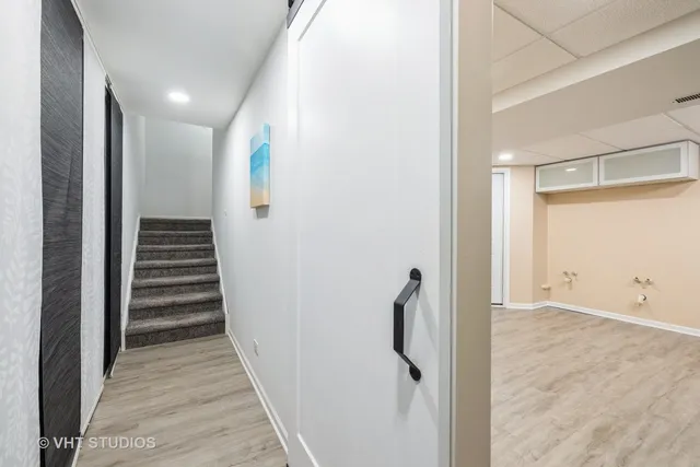 a view of a hallway with wooden floor and entryway