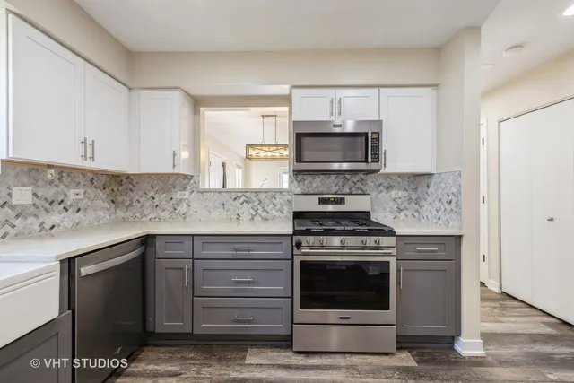 a kitchen with cabinets stainless steel appliances and wooden cabinets