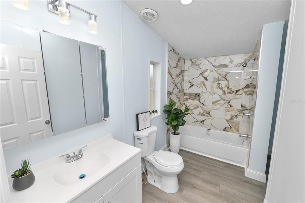 18805 St Paul Drive Spring Hill, FL 34610 - Photo 12 of 20 a bathroom with a sink a toilet and shower