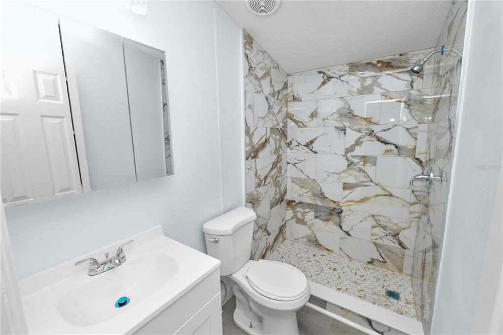 18805 St Paul Drive Spring Hill, FL 34610 - Photo 14 of 20 a white toilet sitting next to a bathroom sink