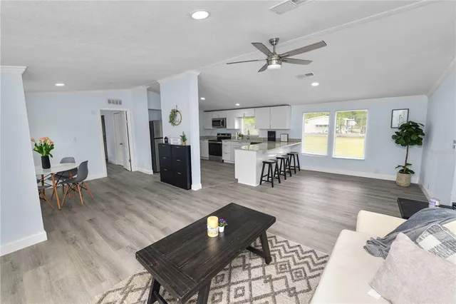 a living room with furniture wooden floor and a table