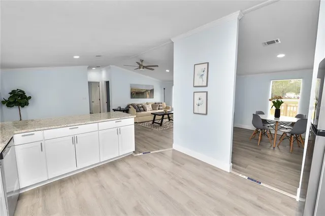 a large white kitchen with cabinets