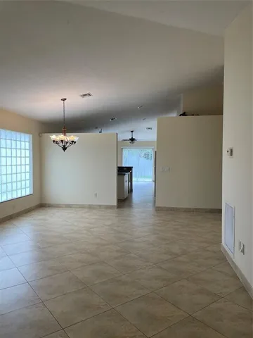 a view of a room with wooden floor and window