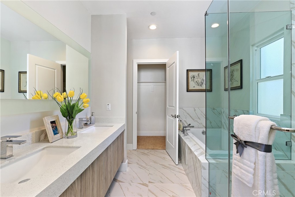 5 Turnberry Lane Phillips Ranch, CA 91766 - Photo 27 of 63 a bathroom with a double vanity sink a mirror and a bathtub