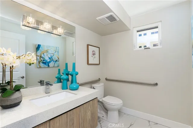 a living room with furniture and a view of kitchen