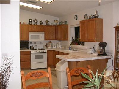 68688 Durango Road Cathedral City, CA 92234 - Photo 7 of 14 a kitchen with a sink stove and cabinets
