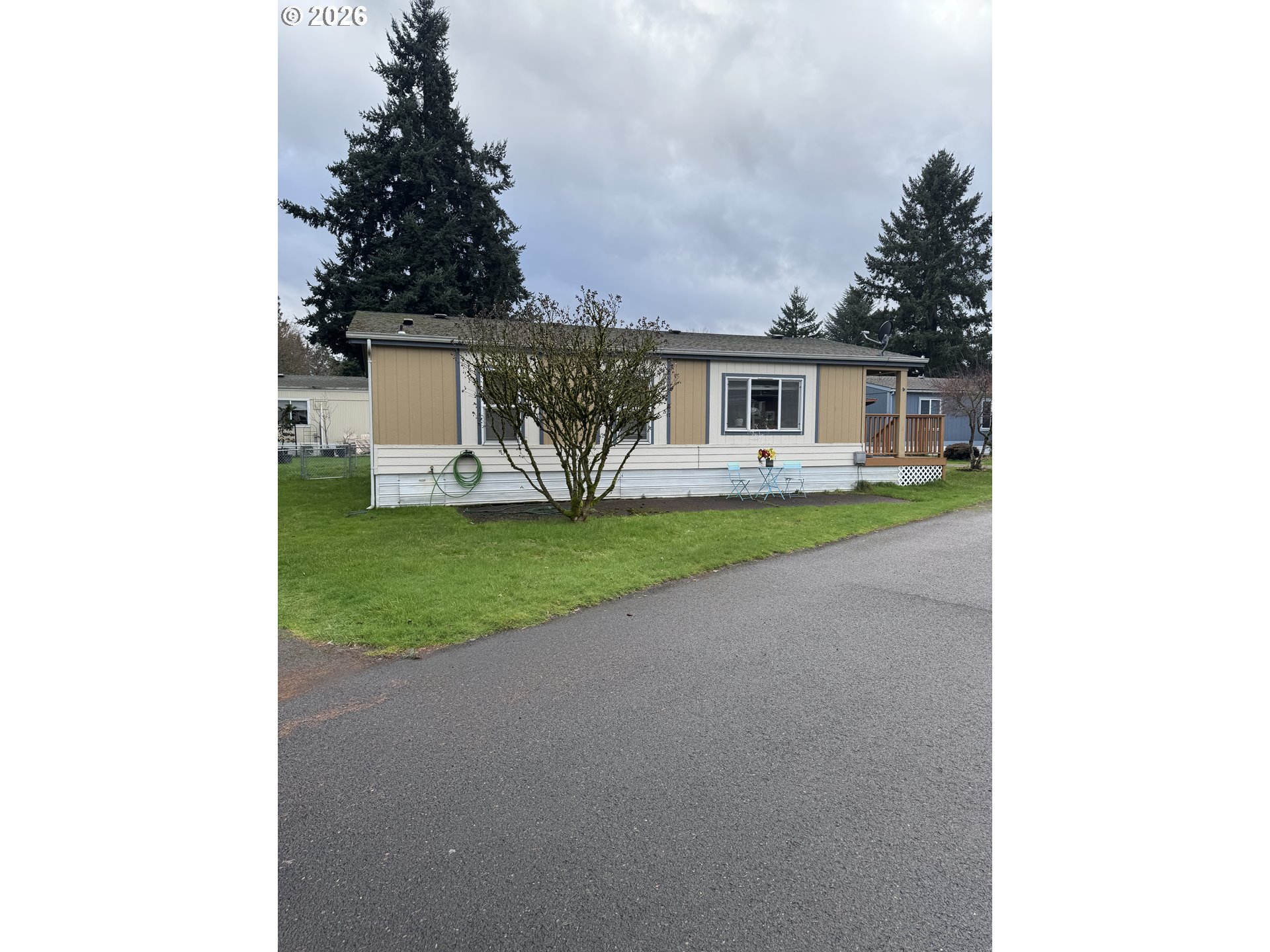 a view of a house with a yard and potted plants