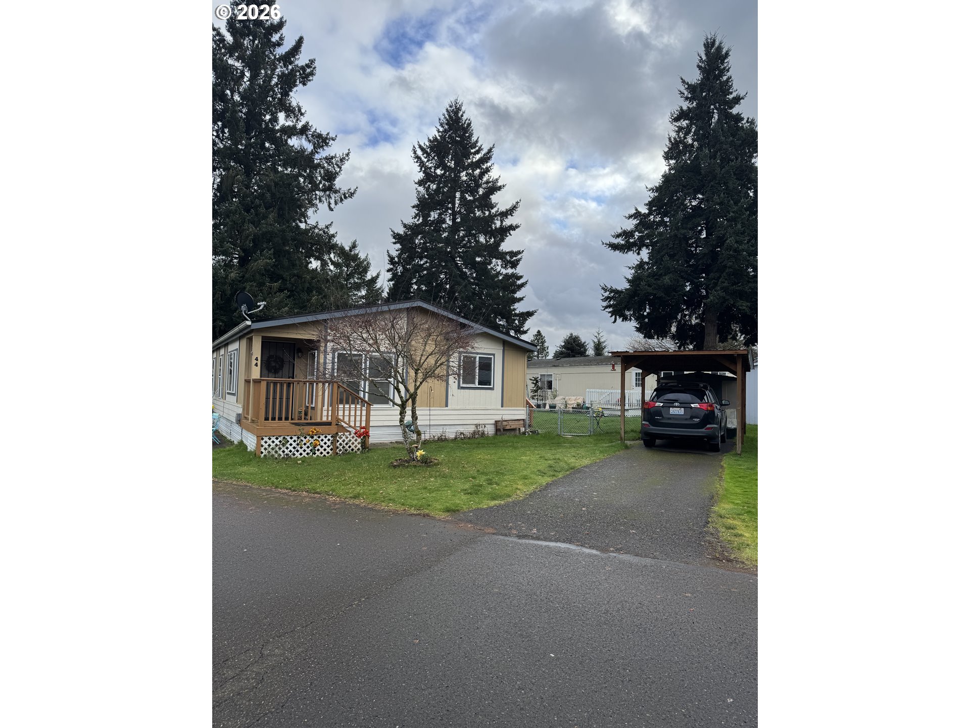 15619 Northeast Caples Road, Unit 44 Brush Prairie, WA 98606 - Photo 2 of 14 a front view of a house with garden