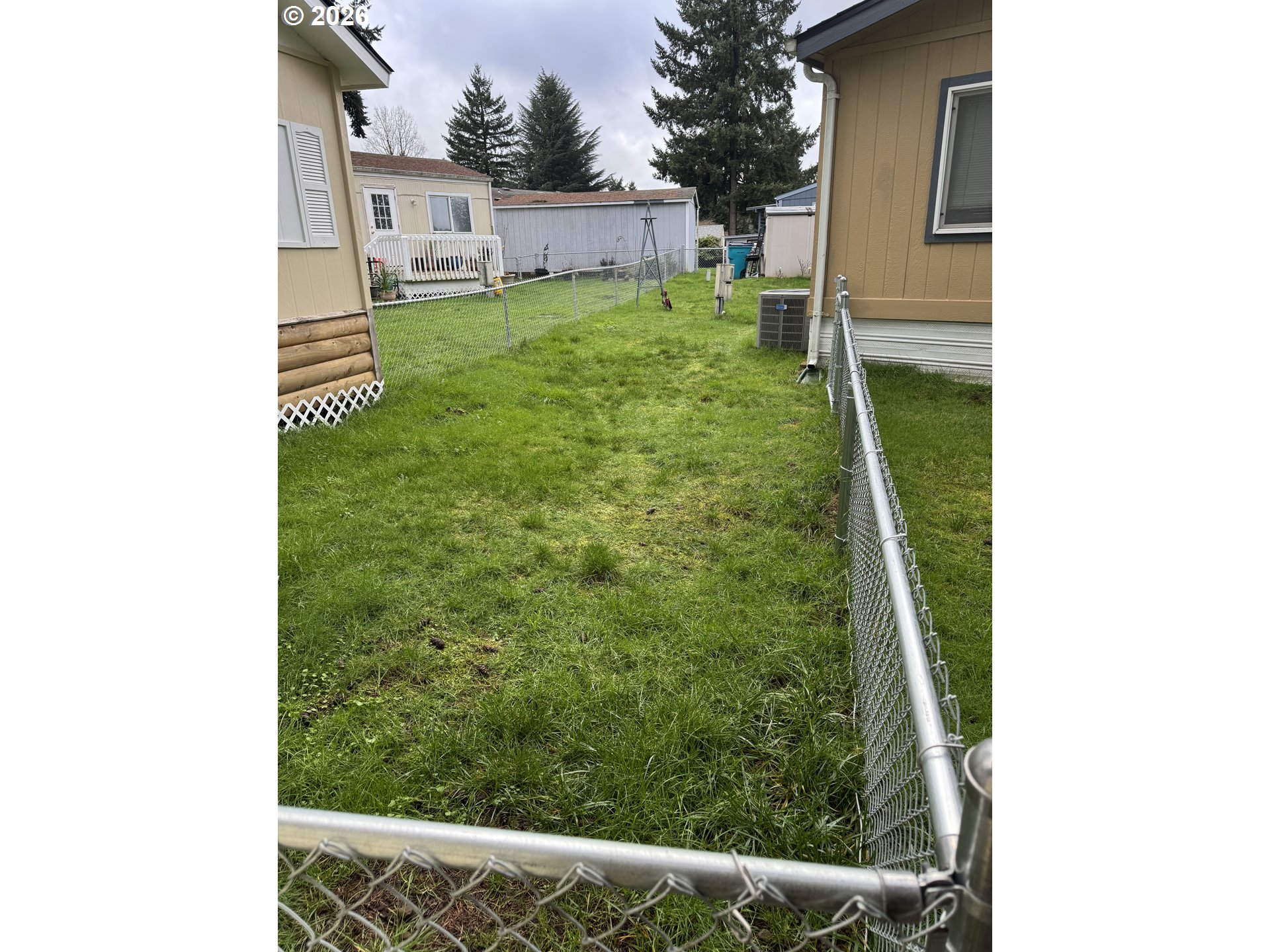 15619 Northeast Caples Road, Unit 44 Brush Prairie, WA 98606 - Photo 5 of 14 a backyard of a house with a garden and plants