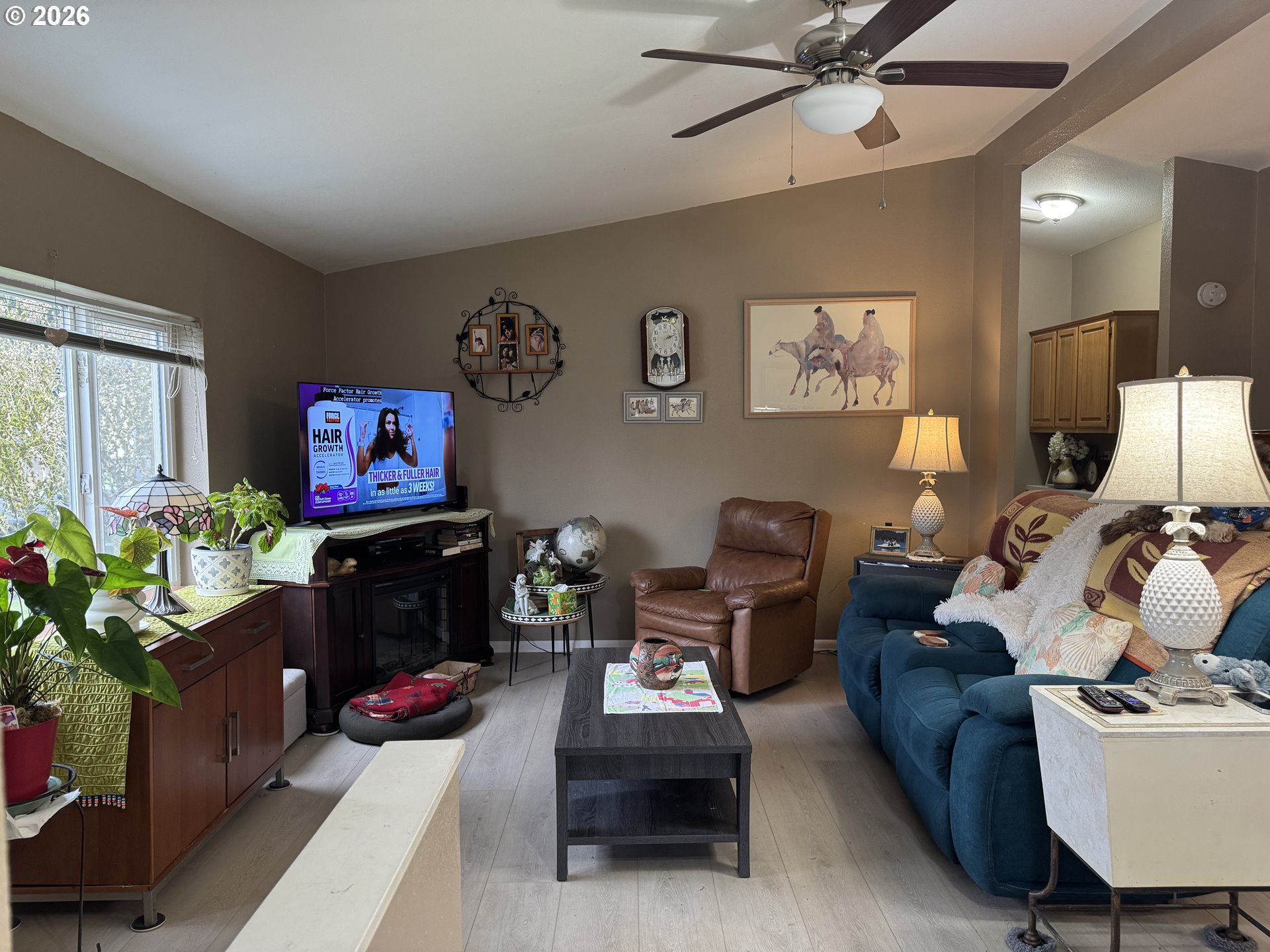 15619 Northeast Caples Road, Unit 44 Brush Prairie, WA 98606 - Photo 8 of 14 a living room with furniture a window and a flat screen tv