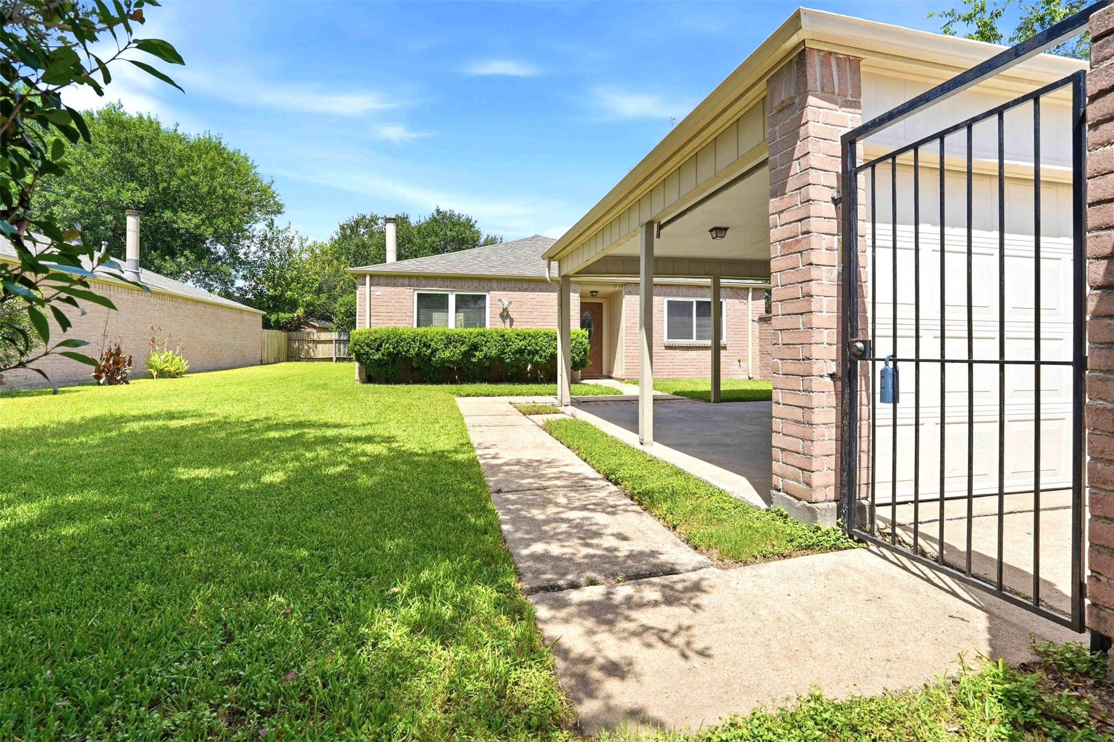7502 Addicks Clodine Road Houston, TX 77083 - Photo 1 of 30 Privacy gate leads you into front yard, garage and home