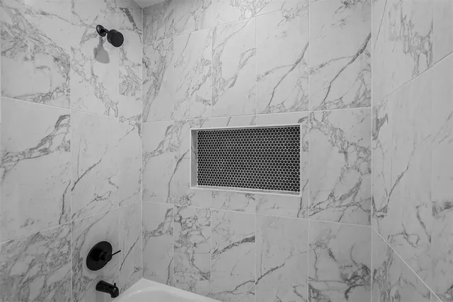 a bathroom with a shower and a mirror