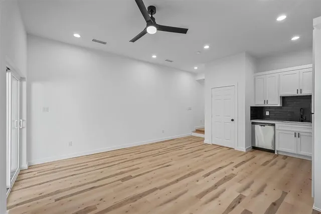 a view of kitchen with granite countertop cabinets and wooden floor