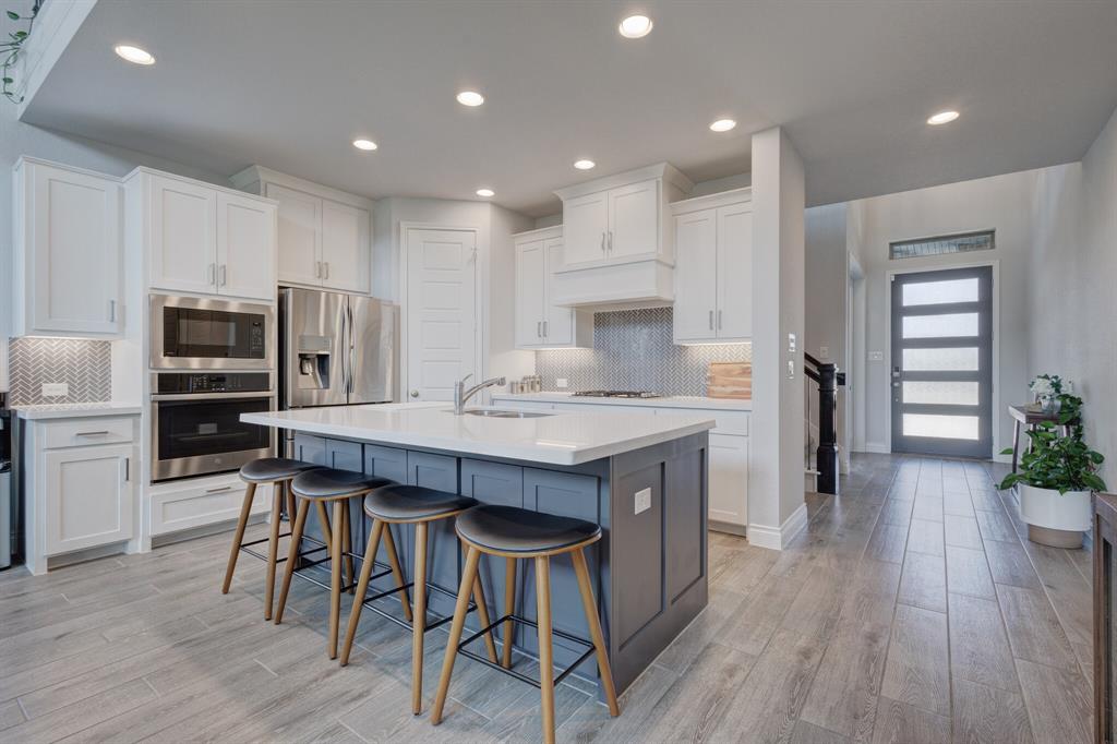830 Knoxbridge Road Forney, TX 75126 - Photo 13 of 36 a kitchen with a table and chairs in it