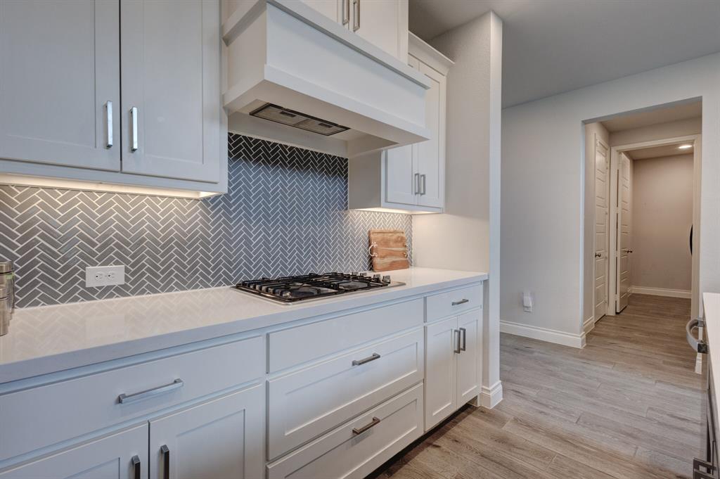 830 Knoxbridge Road Forney, TX 75126 - Photo 16 of 36 a kitchen with granite countertop white cabinets and a stove