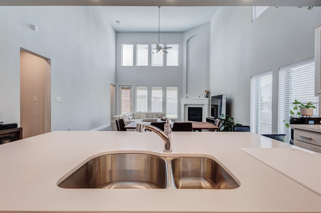 830 Knoxbridge Road Forney, TX 75126 - Photo 18 of 36 a kitchen with a sink cabinets and chandelier