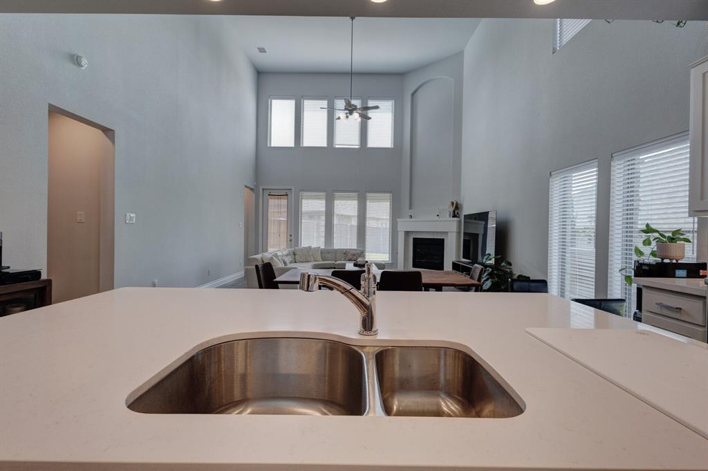 830 Knoxbridge Road Forney, TX 75126 - Photo 19 of 36 a kitchen with a sink a counter top space and living room view