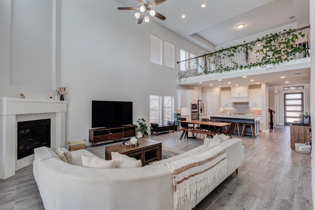 830 Knoxbridge Road Forney, TX 75126 - Photo 25 of 36 a living room with furniture and a fireplace