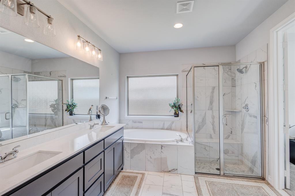 830 Knoxbridge Road Forney, TX 75126 - Photo 29 of 36 a spacious bathroom with a shower sink and mirror