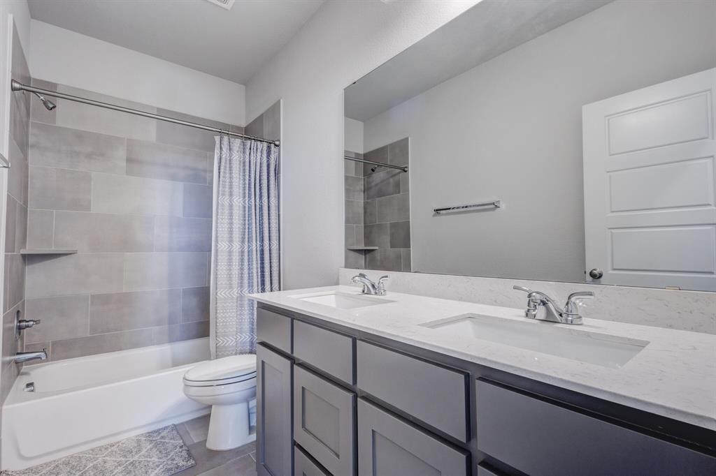830 Knoxbridge Road Forney, TX 75126 - Photo 35 of 36 a bathroom with a granite countertop sink toilet and shower