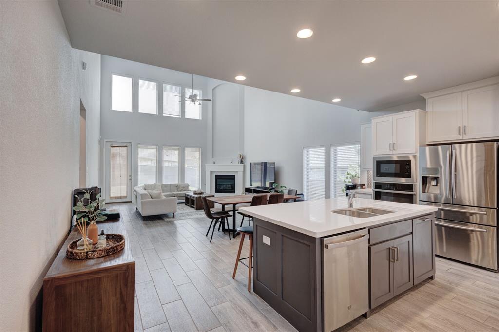 830 Knoxbridge Road Forney, TX 75126 - Photo 8 of 36 a kitchen that has a sink and a stove in it