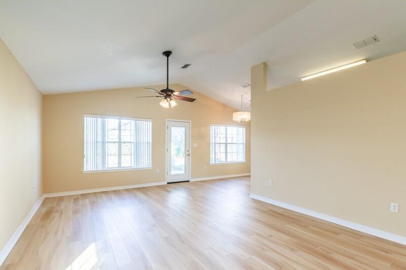 1607 Ella Ruth Drive Fort Walton Beach, FL 32547 - Photo 11 of 31 a view of an empty room with wooden floor and a window