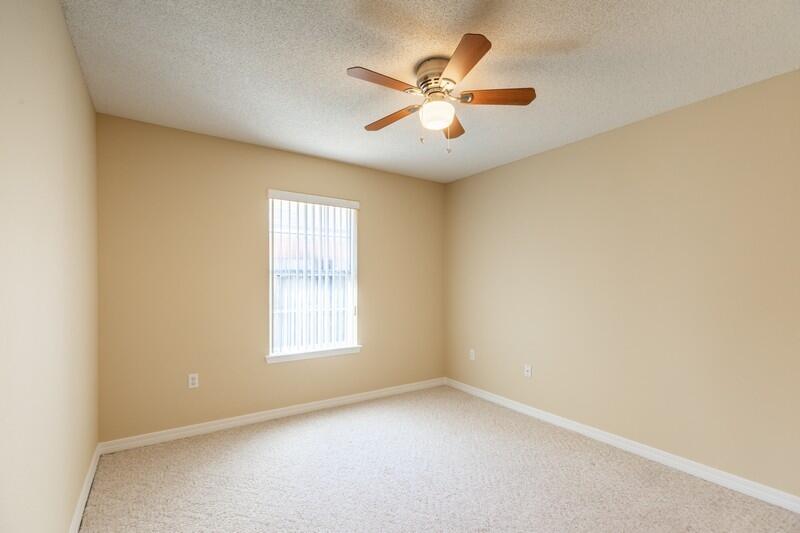 1607 Ella Ruth Drive Fort Walton Beach, FL 32547 - Photo 23 of 31 an empty room with windows and fan