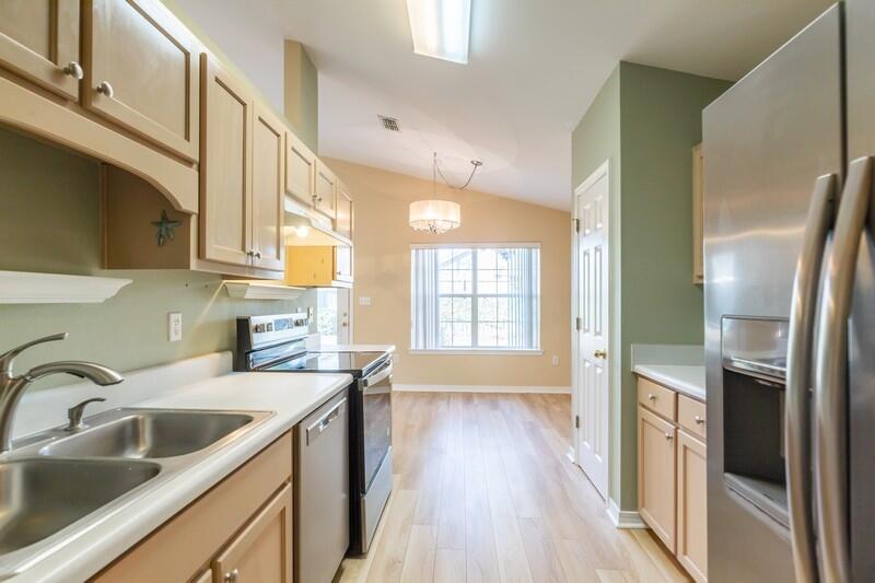 1607 Ella Ruth Drive Fort Walton Beach, FL 32547 - Photo 5 of 31 a kitchen with a sink a refrigerator and wooden floor