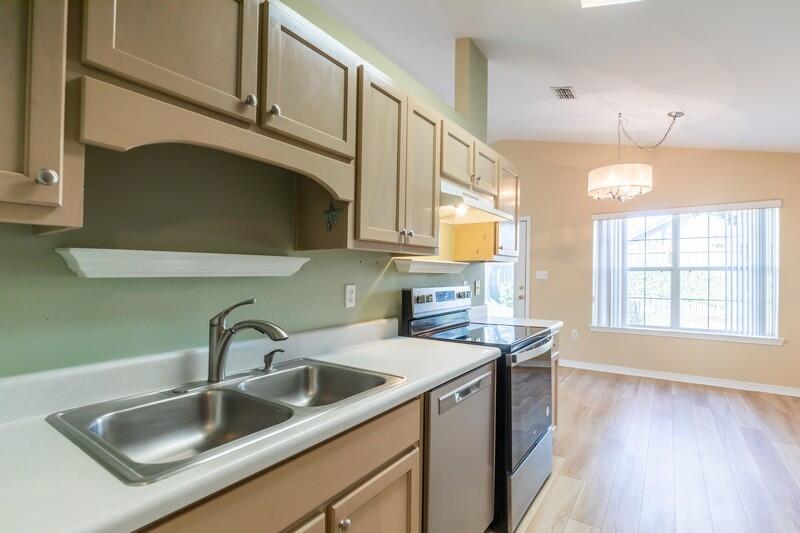 1607 Ella Ruth Drive Fort Walton Beach, FL 32547 - Photo 6 of 31 a kitchen with stainless steel appliances a sink a stove and a wooden floor