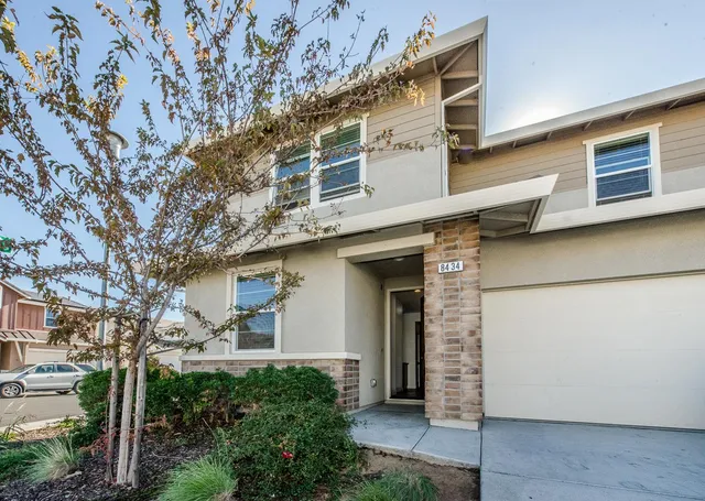 a view of a house with a tree