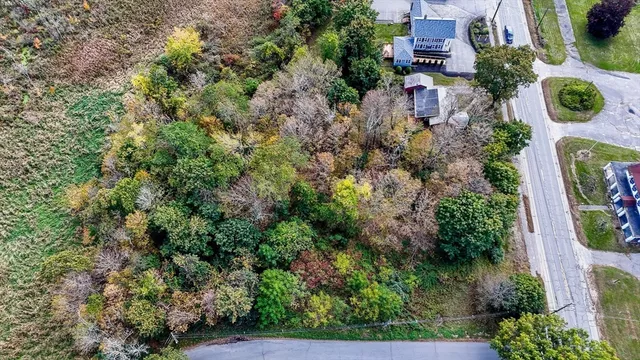 an aerial view of a house with lots of trees