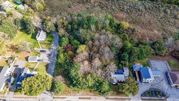 an aerial view of a houses with yard