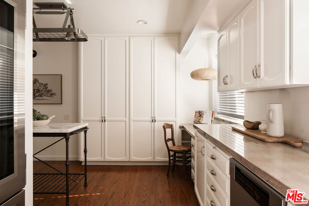 10225 Valley Spring Lane Toluca Lake, CA 91602 - Photo 11 of 35 a kitchen with stainless steel appliances a sink cabinets and wooden floor