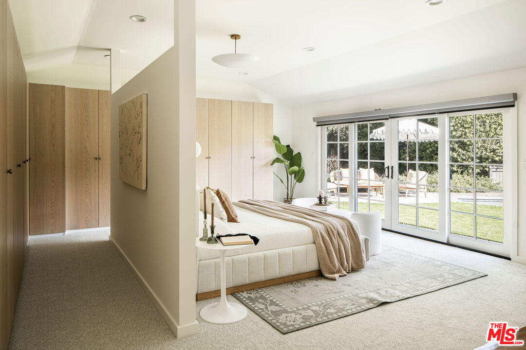 10225 Valley Spring Lane Toluca Lake, CA 91602 - Photo 15 of 35 a bed room with a bed and a large window