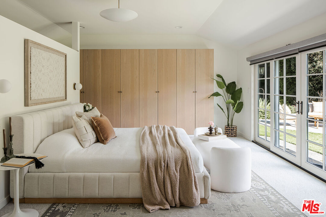 10225 Valley Spring Lane Toluca Lake, CA 91602 - Photo 16 of 35 a bedroom with a bed and a large window