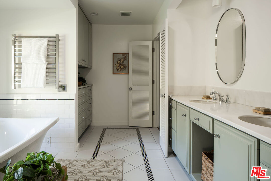 10225 Valley Spring Lane Toluca Lake, CA 91602 - Photo 19 of 35 a bathroom with a sink and a mirror
