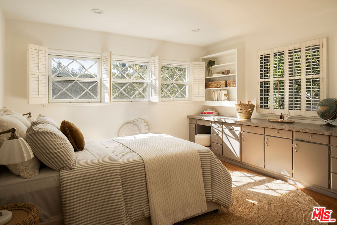 10225 Valley Spring Lane Toluca Lake, CA 91602 - Photo 21 of 35 a bedroom with a bed and a large window