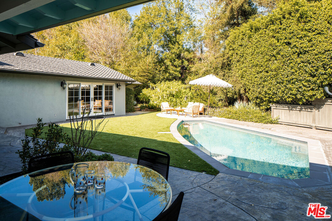 10225 Valley Spring Lane Toluca Lake, CA 91602 - Photo 29 of 35 a view of a swimming pool with a patio