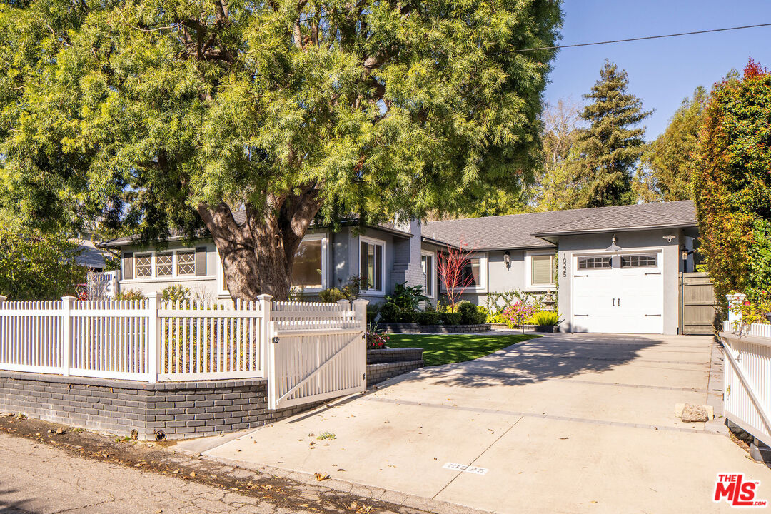 10225 Valley Spring Lane Toluca Lake, CA 91602 - Photo 32 of 35 a front view of a house with a garden