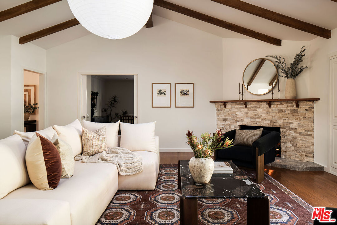 10225 Valley Spring Lane Toluca Lake, CA 91602 - Photo 6 of 35 a living room with furniture a fireplace and a potted plant