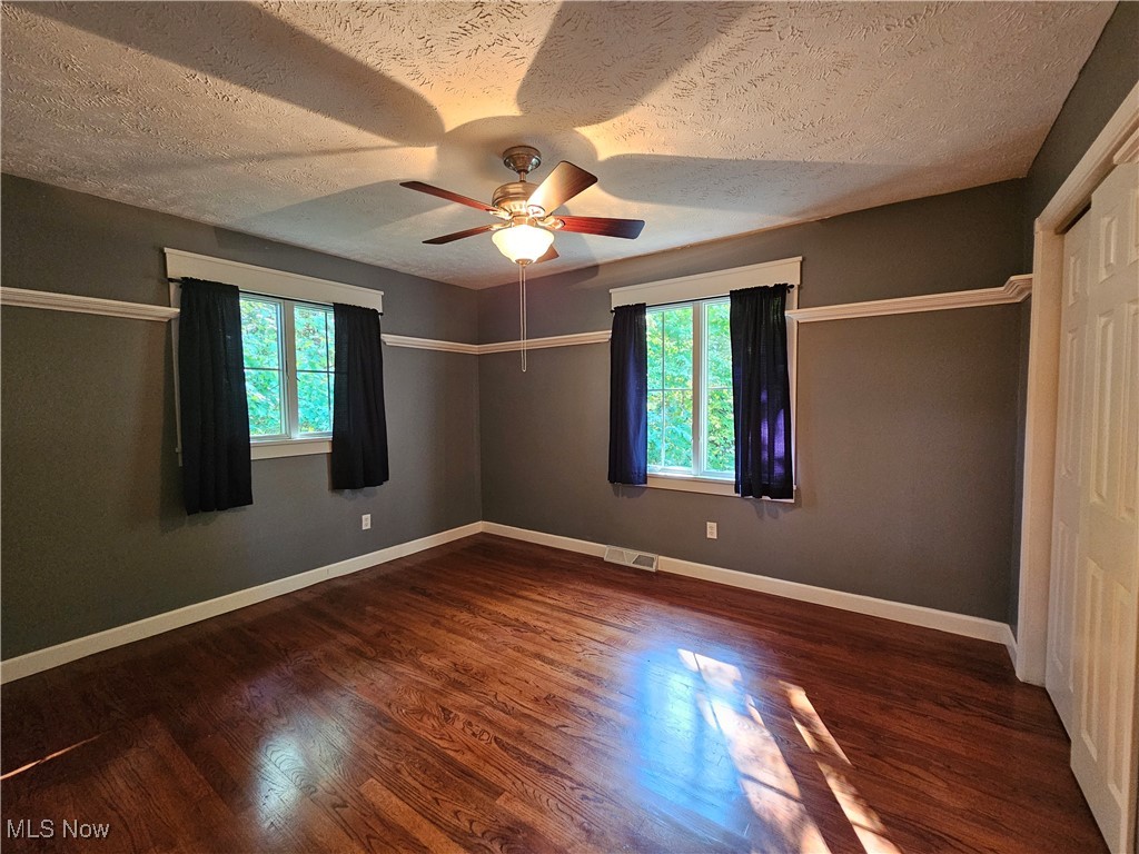 6155 Beach Road Wadsworth, OH 44281 - Photo 24 of 49 Second bedroom featuring ceiling fan, a textured ceiling, and dark hardwood floors