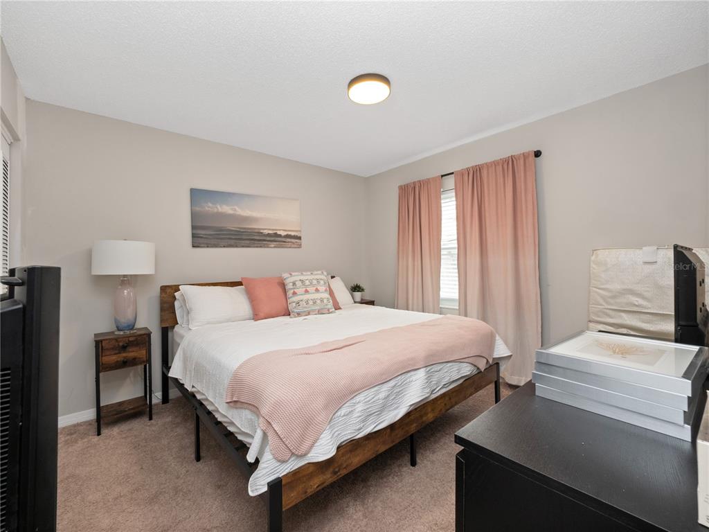 2733 Middle Street Orlando, FL 32807 - Photo 16 of 23 a bedroom with a bed and a lamp