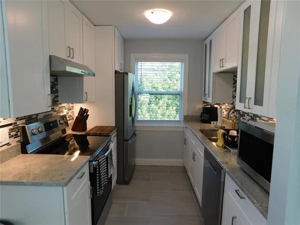 a kitchen that has a sink and a stove